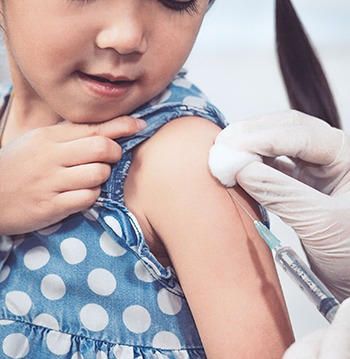 Doctor injecting vaccination in arm of asian little child girl,healthy and medical concept